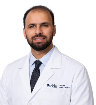 Dr. Muhammad T. Padela in a white coat