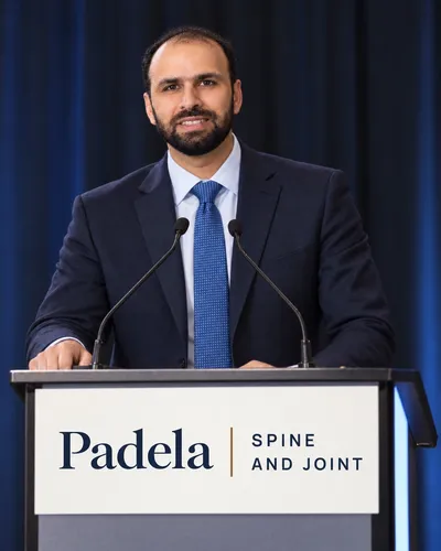 Dr. Padela speaking at a podium